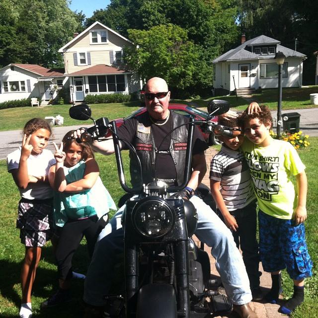 John Riegler and his grandkids on his motorcycle.jpg